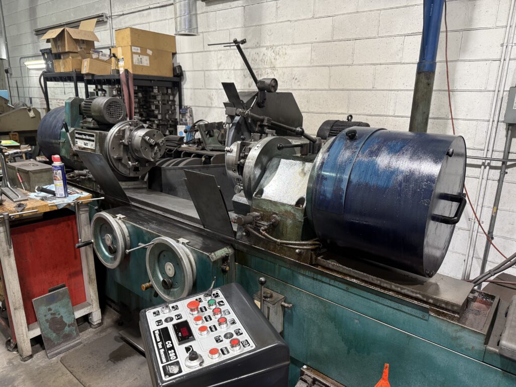 Used Winona Van Norman CG280 crankshaft grinder with crankshaft mounted and control panel visible